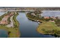 An aerial view of a waterfront community with a serene lake, lush landscaping, and charming homes with private boat docks at 7833 Freestyle Ln, Winter Garden, FL 34787