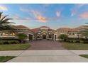 Beautiful single-story home with a tile roof, stone accents, landscaped front yard, and a brick driveway leading to garage at 7833 Freestyle Ln, Winter Garden, FL 34787