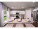 Modern kitchen with white cabinets, stainless steel appliances, and an island at 1596 Ellesmere Ave, Haines City, FL 33844