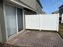 Private patio with brick pavers and a white fence at 6528 Sedgeford Dr, Lakeland, FL 33811
