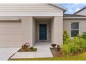 House entrance with a blue door and walkway at 1536 Axel Cir, Winter Haven, FL 33880
