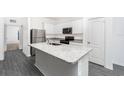 A close-up view of the island sink and granite countertops in the kitchen at 308 Bass Ct, Poinciana, FL 34759