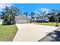 Long driveway leading to a charming house with a two-car garage at 4714 Dail Rd, Lakeland, FL 33813