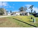 House exterior with a large green lawn and mature trees at 4714 Dail Rd, Lakeland, FL 33813