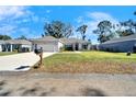 House exterior showcasing a spacious front yard and driveway at 4714 Dail Rd, Lakeland, FL 33813