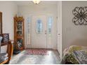 Front entry with white door, tiled floor, and decorative rug at 3189 Winchester Estates Loop, Lakeland, FL 33810