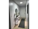 Clean and well-lit hallway with a console table and mirror at 401 Century Blvd # C, Auburndale, FL 33823