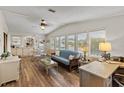 Bright living room featuring a comfortable sofa and wood floors at 1724 Magnolia Ave, Lady Lake, FL 32159