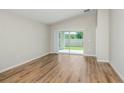 Living area with sliding glass doors opening to the backyard and wood flooring throughout at 6230 Sw 96Th Pl, Ocala, FL 34476