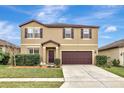 Two-story house with brown accents and a landscaped lawn at 8710 Hinsdale Heights Dr, Polk City, FL 33868
