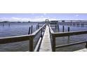 Wooden walkway over water leading to a pier at 900 S Peninsula Dr # 102, Daytona Beach, FL 32118