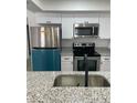 Modern kitchen featuring stainless steel appliances and granite countertops at 1227 Waterview W Blvd, Lakeland, FL 33801