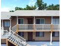 Two-story building exterior with stairs and balconies at 411 N Halifax Ave # 104, Daytona Beach, FL 32118