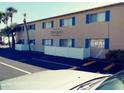Building exterior with parking and signage at 411 N Halifax Ave # 104, Daytona Beach, FL 32118