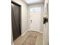Modern entryway with a white door and dark brown accent door at 5450 Sunshine Dr, Wildwood, FL 34785