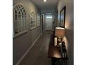 Bright hallway with tile flooring and decorative mirrors at 5450 Sunshine Dr, Wildwood, FL 34785