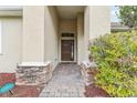 Front entry with stone accents and landscaping at 4026 Navigator Way, Kissimmee, FL 34746