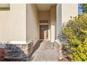 Charming home entry featuring a decorative brick walkway and lush landscaping at 4026 Navigator Way, Kissimmee, FL 34746