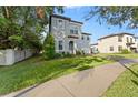 Two-story house with gray siding, a brick driveway, and lush green lawn at 213 Aidans Ldg, Haines City, FL 33844