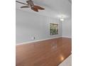 Spacious living room featuring hardwood floors and a ceiling fan at 10555 Leader Ln, Orlando, FL 32825