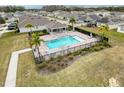 Community pool with surrounding lounge chairs and palm trees at 2130 Sequoia Way, Davenport, FL 33896