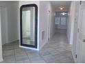 Bright entryway with tile flooring and large mirror at 2180 Nighthawk Dr, Haines City, FL 33844