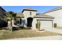 Single-story house with attached garage and landscaped front yard at 2180 Nighthawk Dr, Haines City, FL 33844