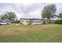 Mobile home with spacious yard and driveway at 6055 Grand Oaks Se Dr, Winter Haven, FL 33884