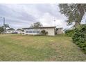 Tan mobile home with large windows and mature tree at 6055 Grand Oaks Se Dr, Winter Haven, FL 33884