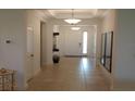 Inviting foyer with decorative mirrors, tile floors, and elegant lighting fixtures at 621 San Augusto Dr, Poinciana, FL 34759