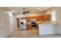 Kitchen boasts stainless steel appliances and light wood cabinets at 2938 Egrets Landing Dr, Lake Mary, FL 32746