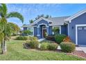 Curb appeal abounds with this lovely blue home and well-manicured landscaping at 4545 Mandolin Blvd, Winter Haven, FL 33884