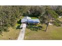 Aerial view showing house, carport, and surrounding trees at 1507 Hontoon Rd, Deland, FL 32720