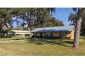 Attractive house with a metal roof, complemented by a convenient carport at 1507 Hontoon Rd, Deland, FL 32720