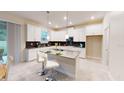 Modern kitchen featuring white cabinets, gray countertops, and a breakfast bar at 3207 Armstrong Ave, Clermont, FL 34714