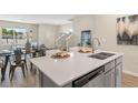 Kitchen island with a white quartz countertop and double sink at 5758 Meditation Dr, Clermont, FL 34714