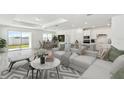 Bright, open-concept living room featuring white sectional sofa, dining area, and modern kitchen with stainless steel appliances at 1254 Lakeridge Way, Lake Alfred, FL 33850