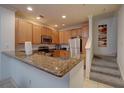 Modern kitchen with granite countertops and stainless steel appliances at 2888 Bella Vista Dr, Davenport, FL 33897