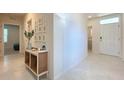 Bright and airy entryway with a console table and modern decor at 30364 Armenia Rd, Leesburg, FL 34748