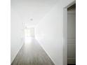 Bright hallway with stylish gray flooring leading to a bright living space and featuring clean, white walls at 2449 Jungle St, Lakeland, FL 33801