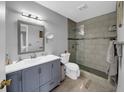 Modern bathroom with a walk-in shower and gray vanity at 260 Winter Ridge Blvd # 38, Winter Haven, FL 33881