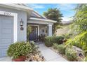 Welcoming front entrance with a dark door, porch, and lush landscaping at 3782 Hampton Hills Dr, Lakeland, FL 33810