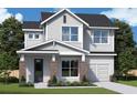 Two-story house with gray siding, brick accents, and a two-car garage at 1701 Ferris Ave, Orlando, FL 32803