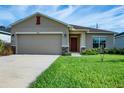 Newly built one-story house featuring a two-car garage and a neat front yard at 2871 Parkfield Rd, St Cloud, FL 34772