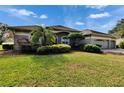 House with a two-car garage and lush green lawn at 958 Lake Deeson Pt, Lakeland, FL 33805