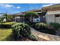 Landscaped entryway with a brick walkway leading to the front door at 958 Lake Deeson Pt, Lakeland, FL 33805