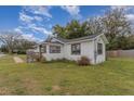 White house with a spacious yard and wooden fence at 100 Cordova Rd, Auburndale, FL 33823