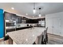 Granite island kitchen with stainless steel appliances at 631 Samuel Pl, Davenport, FL 33837