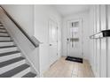 Modern entryway with tiled floors, staircase, and interior door at 2557 Village Lakes Blvd, Lakeland, FL 33805