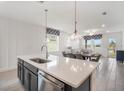 Spacious kitchen with island, stainless steel appliances, and dark cabinets at 2557 Village Lakes Blvd, Lakeland, FL 33805